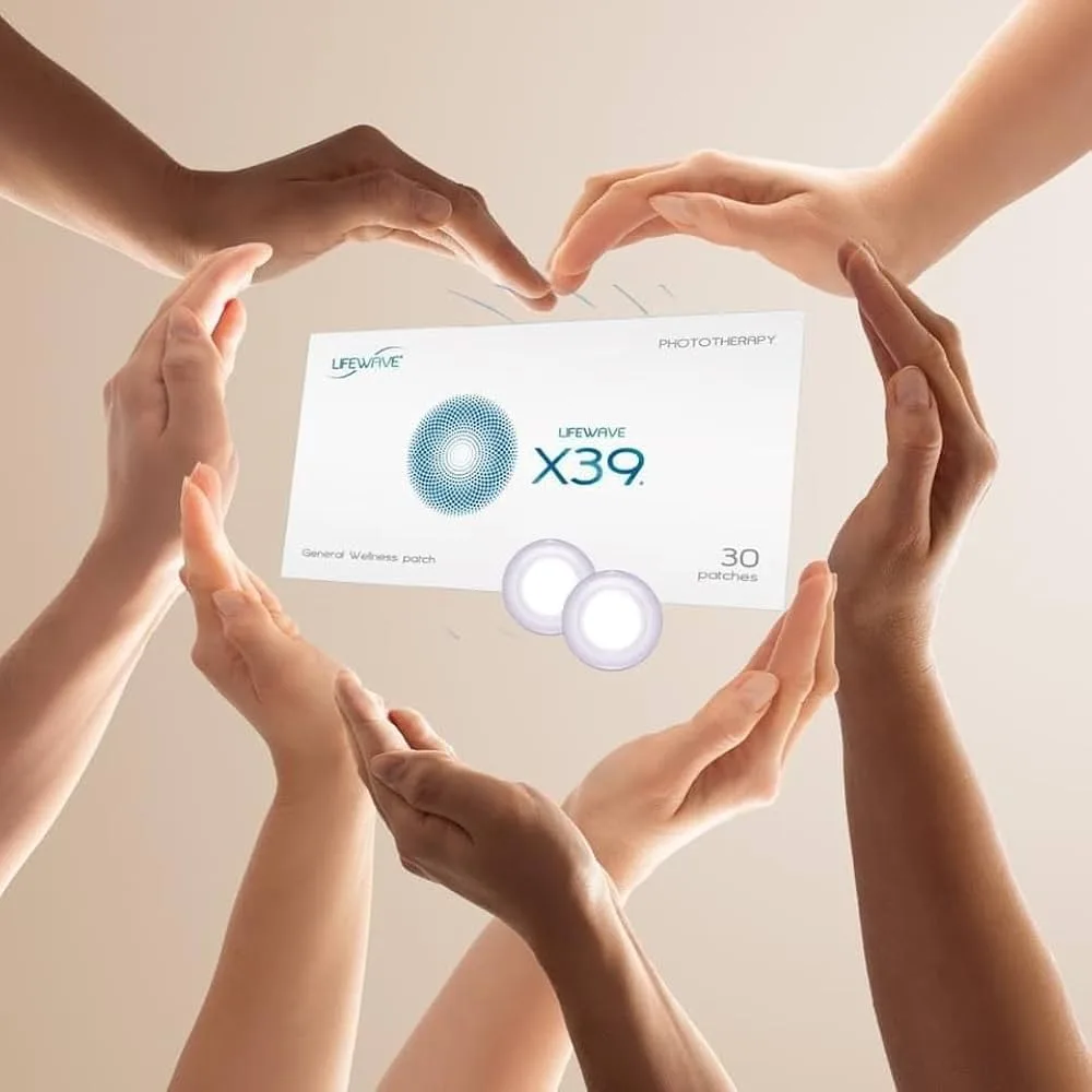 Hands appearing to be of diverse skin tones form a heart around LifeWave X39 patches and box, symbolizing shared wellness.